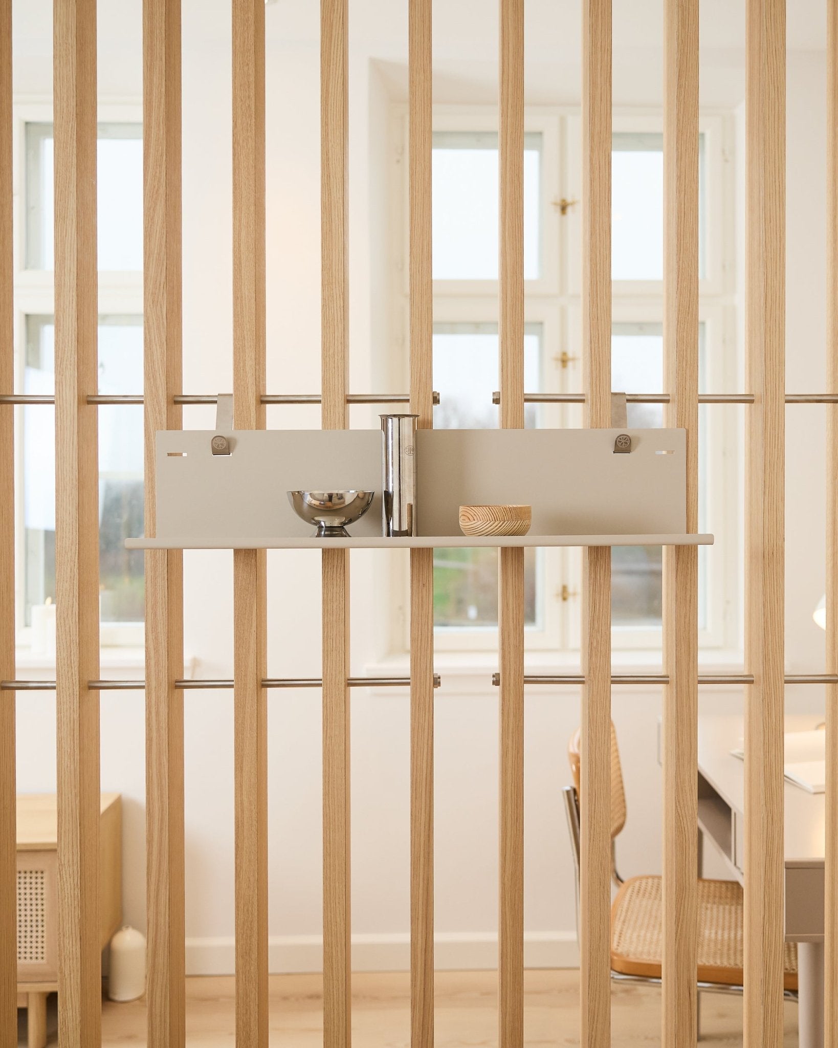 WoodUpp beige Metal Shelf BM1 (63x13.4 cm) holds a bowl, cup, and tall cylinder mounted on vertical acoustic wood slat panels in a bright room.